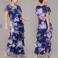 a woman is wearing a blue floral dress with a ruffled hem