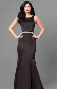 a woman wearing a black mermaid prom dress