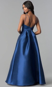 the back of a woman in a blue prom dress