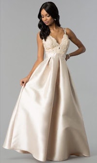 a woman wearing a blush satin prom dress