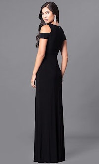 a woman wearing a black long dress with a cold shoulder