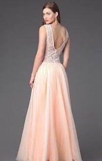 the back view of a woman in a peach prom dress