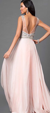 a woman in a pink gown with beading on the back