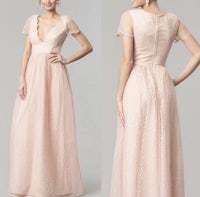 the back view of a woman in a nude gown with a slit