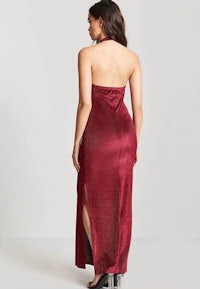 the back view of a woman wearing a burgundy halt dress