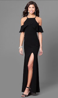 a woman wearing a black dress with a slit