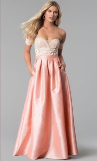 a woman in a pink off the shoulder prom dress