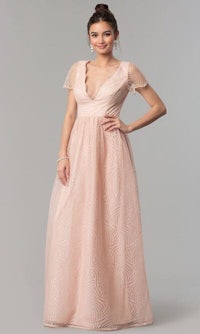 a woman wearing a blush lace gown