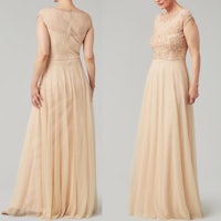 the back view of a woman in a beige evening dress