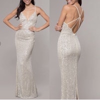 the back view of a woman in a silver sequin gown