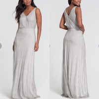a woman in a silver gown with a v - neck