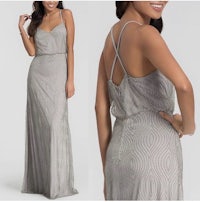 the back view of a woman in a silver gown