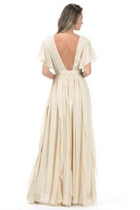 the back view of a woman in a cream dress