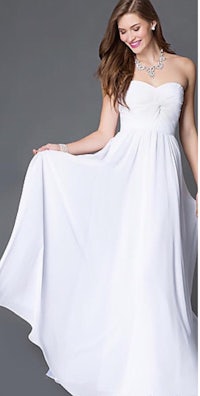 a woman in a white long dress is posing