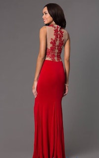 the back of a woman in a red gown with lace and beading