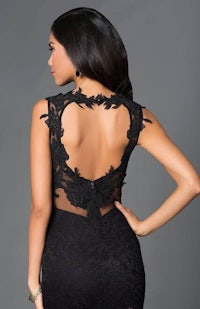 the back of a black lace dress with an open back