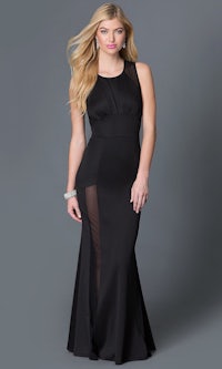 a woman wearing a black evening gown with sheer sleeve