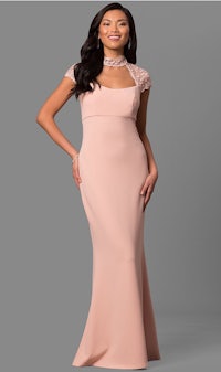 a woman in a blush colored evening gown