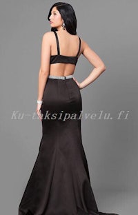 the back view of a woman wearing a black prom dress