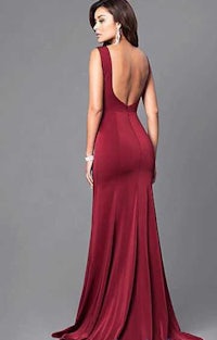 the back view of a woman in a burgundy evening gown