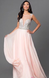 a woman wearing a pink prom dress with beading