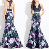 a woman in a black and purple mermaid prom dress