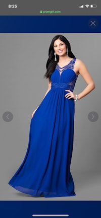 a woman is posing in a blue dress