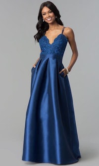 a woman in a blue prom dress with a v - neck and pockets