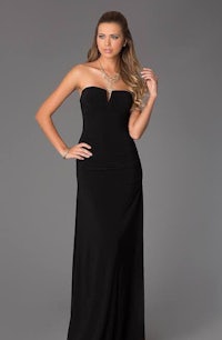 a woman wearing a black strapless prom dress