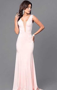 a woman in a pink gown posing for a photo